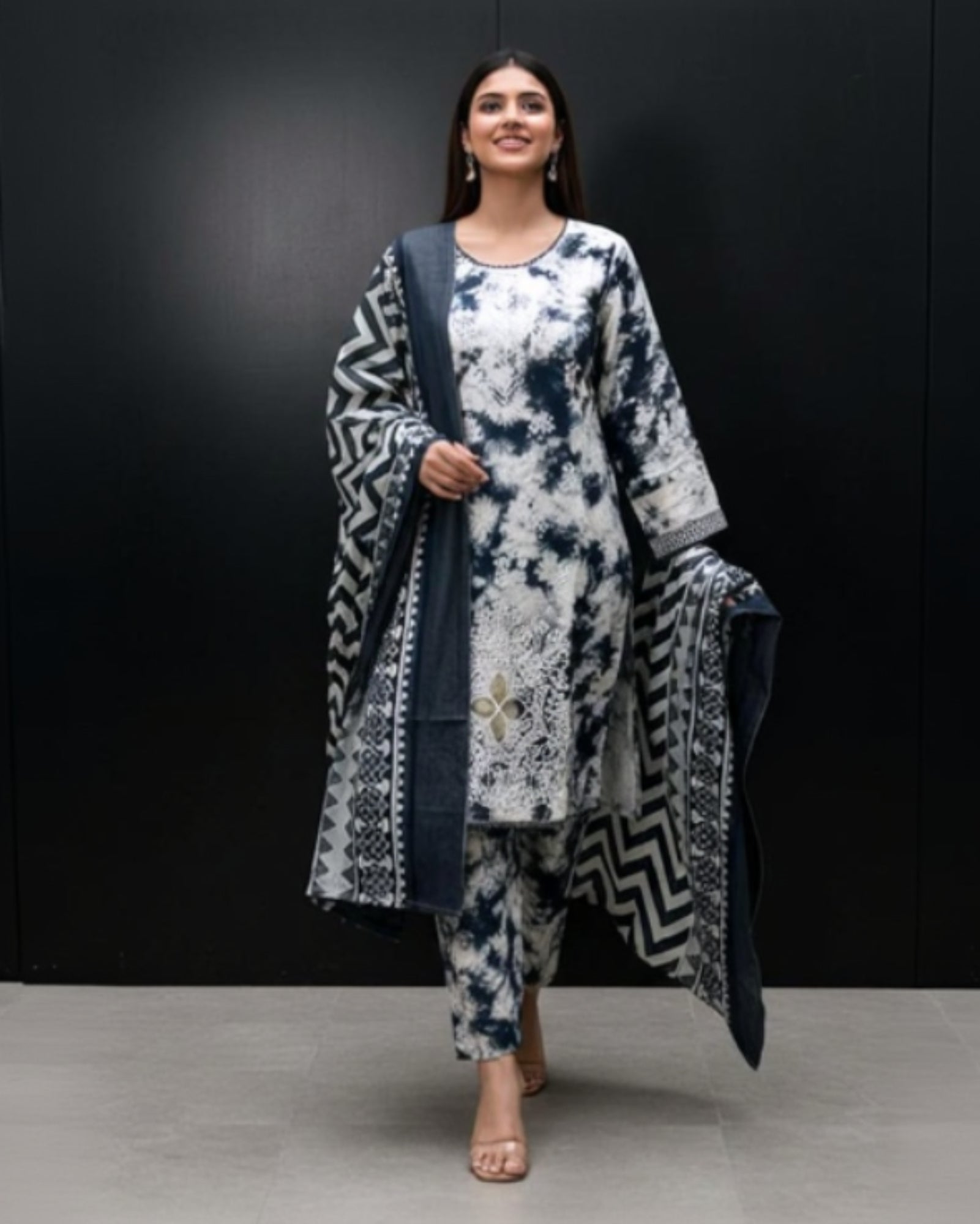 Woman wearing a patterned outfit with a black background