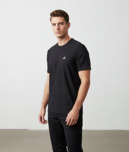 Man wearing a black Adidas t-shirt with a white background