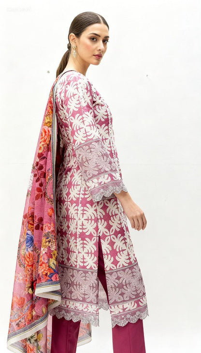 A woman models the Vibrant Patchwork Ensemble—mauve and white embroidered kurta, matching pants, and a floral dupatta—standing against a white background, looking over her shoulder. Perfect for daytime events.
