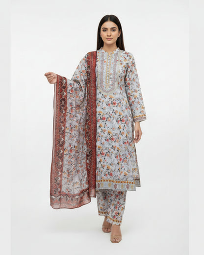 Woman wearing a floral kurta with matching pants and a long scarf on a white background