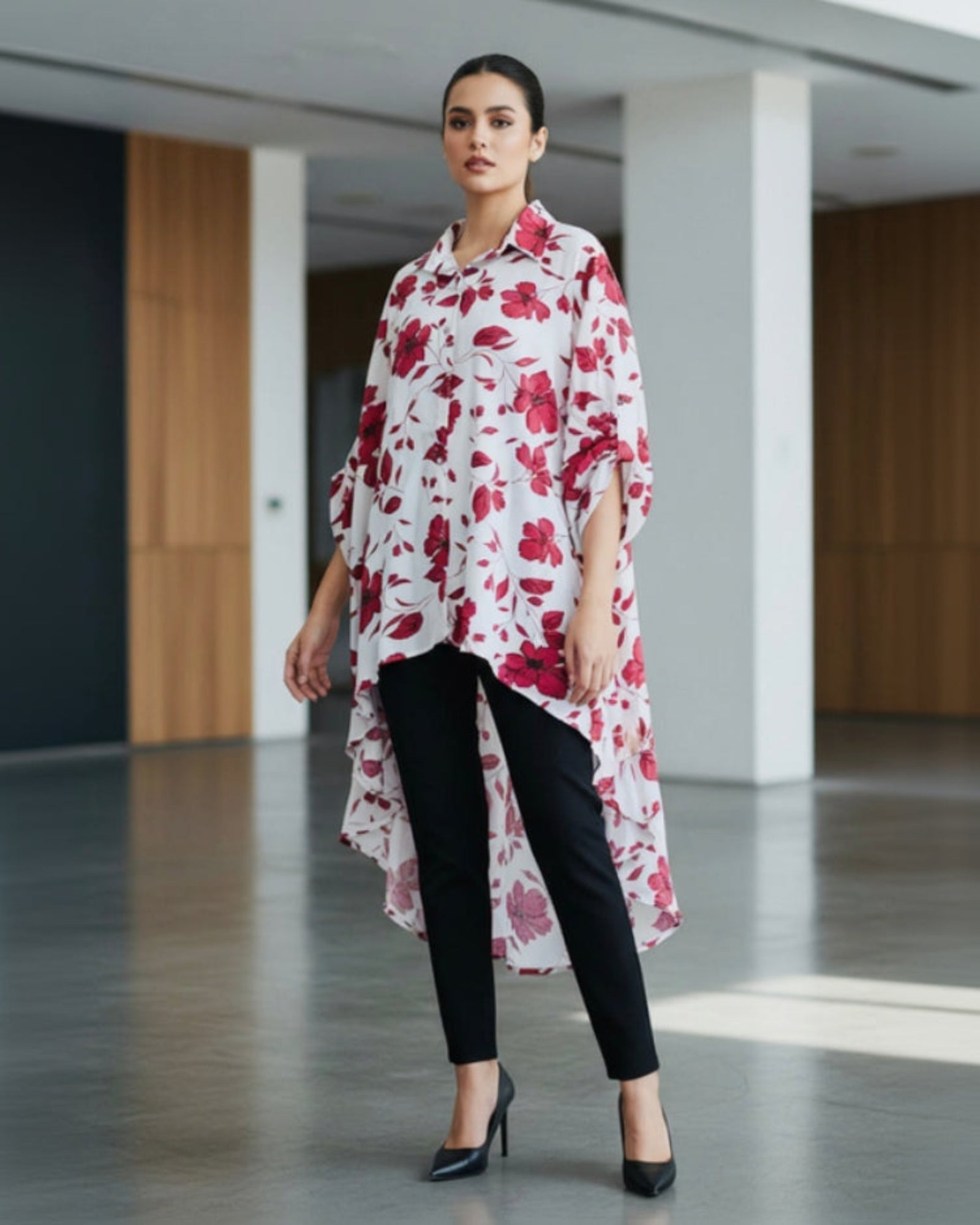 Woman wearing a long floral dress in an indoor setting