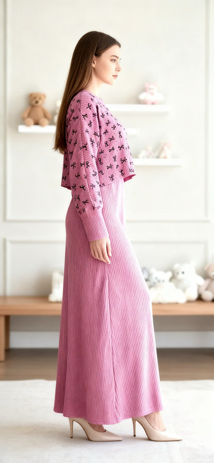 Woman wearing a pink outfit with a floral pattern in a minimalistic room.