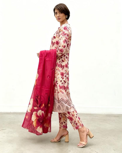 Woman wearing a floral dress with a pink dupatta on a white background