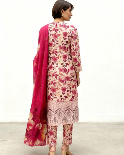 Woman wearing a floral pink outfit with a matching dupatta on a white background