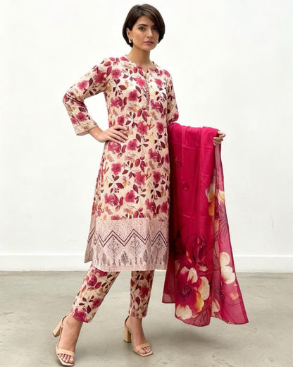 Woman wearing a floral dress and pants with a matching dupatta on a white background