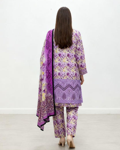 Woman wearing a purple and floral outfit with a matching dupatta on a white background