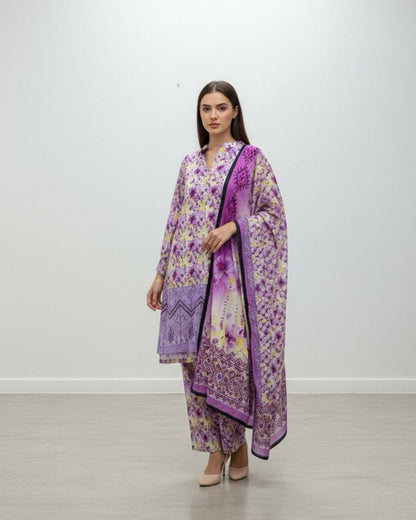 Woman wearing a floral dress with a purple dupatta against a white background