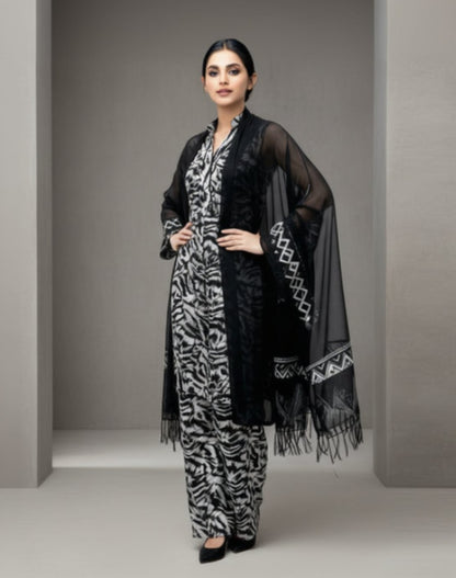 Woman wearing a black and white zebra print outfit with a matching shawl on a white background